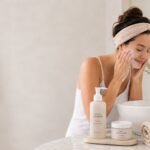 a woman gently washing her face